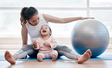 woman, happy baby and floor with exercise ball, laughing and bonding together with fitness, health a