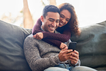 Aufkleber - Happy couple, phone and relax on sofa with social media, internet and online streaming service at home. Young interracial woman and man or partner on video call, connection or hug or love on couch