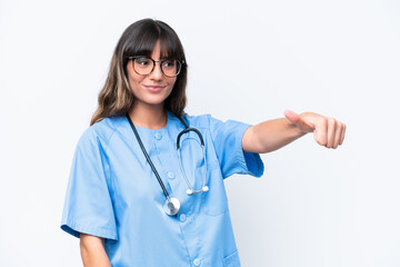 Wall Mural - Young caucasian nurse woman isolated on white background giving a thumbs up gesture