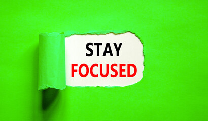 Stay focused symbol. Concept words Stay focused on beautiful white paper on a beautiful green background. Business, support, motivation, psychological and stay focused concept. Copy space.