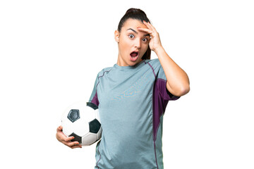 Wall Mural - Young football player Woman over isolated chroma key background doing surprise gesture while looking to the side