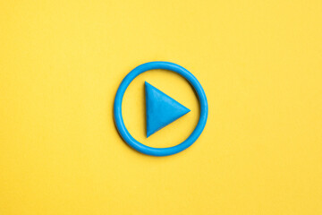 3d simple play button, 3d media play sign on yellow background. plasticine object.