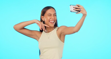 Wall Mural - Woman, selfie and happiness with influencer and social media post, memory and carefree on blue background. Mockup space, energy with young female person smile and pose in picture with live stream