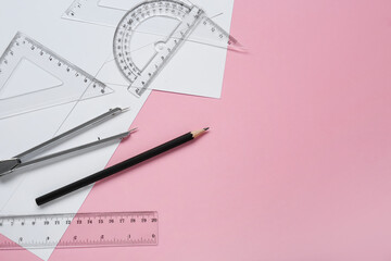 Wall Mural - Different rulers, pencils and compass on pink background, flat lay. Space for text