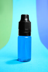 Wall Mural - Bottle with light blue food coloring on bright background