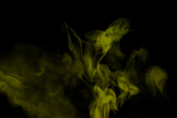 Wall Mural - yellow smoke on a black background.