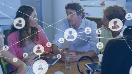 Canvas Print - Animation of connected icons over diverse coworkers discussing strategy in meeting at office