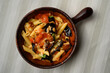 Pasta alla Norma or Penne Rigate with Eggplant and Tomato Sauce and Ricotta in a Rustic Terracotta Bowl