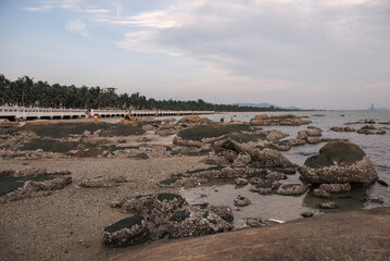 Chon buri Thailand, 24 Dec 2021, Front view of the view Bangsaen Beach blue sky palm tree whit Atmosphere. Tourists people enjoy trip travel are relaxing at the beach during sunset summer in vacation.