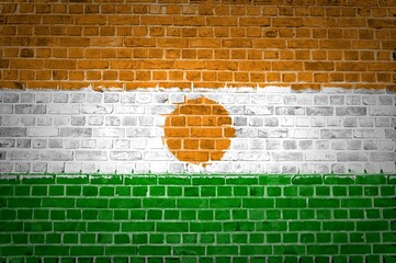 Sticker - Shot of the Niger flag painted on a brick wall in an urban location