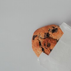 Poster - Closeup of a chocolate cheap cookie with a packaging on gray background