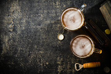 Canvas Print - Beer in glasses with an old crate of bottles.