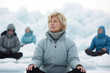 © Anne Schaum - Mature woman meditating in lotus position on background of icebergs