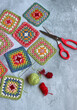 Handmade crocheted multicolored squares with embroidery patterns