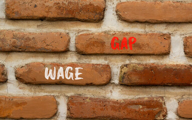 Wage gap symbol. Concept words Wage gap on beautiful brown brick wall on a beautiful brown brick wall background. Business, support and wage gap concept. Copy space.