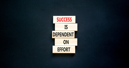 Wall Mural - Success and effort symbol. Concept words Success is dependent on effort on wooden block. Beautiful black table black background. Business success and effort concept. Copy space.