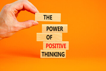 Wall Mural - Positive thinking symbol. Concept words The power of positive thinking on wooden block. Beautiful orange background. Businessman hand. Business, motivational positive thinking concept. Copy space.