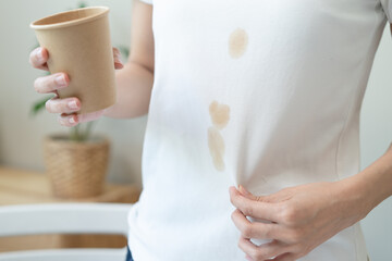 Wall Mural - Clothes stain dirty from food concept, people get a coffee drop split from glass on the t-shirt.