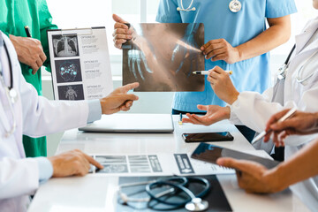 A team of young doctors discuss CT scan results in the clinic. Show patient results at the modern advanced diagnostic center. medical and health concept