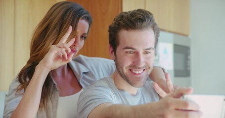 Poster - Young couple, peace and selfie in home kitchen with hug, happiness and smile together for social media. Man, woman and happy with photography, comic profile picture and happy for blog, app or post