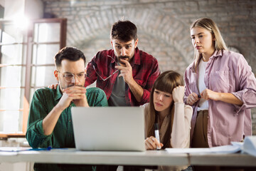 Young freelance workers having problems while working on laptop in the office