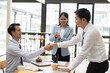 © PaeGAG - Business people shaking hands, finishing up a meeting.