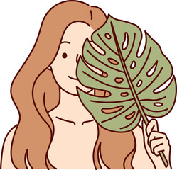 Sticker - Beautiful woman applies leaf from palm tree to face, symbolizing natural cosmetic product for skin