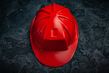 Wall Mural - Red Construction Helmet On Dark Stone Background.