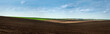 © pavlobaliukh - Big panoramic view of colorful hills of plowed dark land and green fields