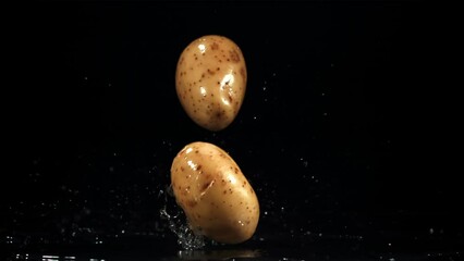 Wall Mural - Potatoes fall on the table. Filmed is slow motion 1000 fps. High quality FullHD footage