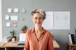 © Adriana - Confident stylish mature mid aged woman standing at home office. Mature businesswoman, blond lady executive business leader manager looking at camera arms crossed, generative AI