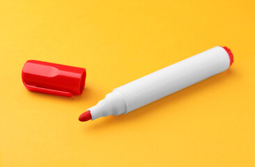 Bright red marker on orange background. School stationery