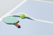 Pickleball Paddle and Ball on Court