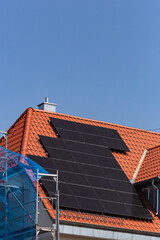 Poster - solar panel on building roof with construction scaffold