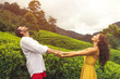© Buyanskyy Production - Couple of Travelers in Love in Front of Tea Plantations in Mountains