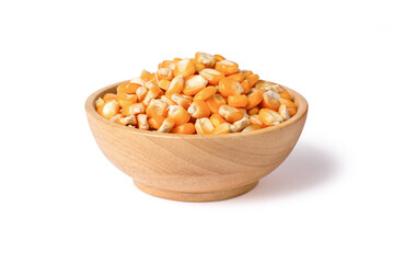 Wall Mural - Dry corn seeds (raw popcorn grains) in wooden bowl isolated on white background with clipping path.