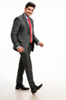 Young indian businessman giving moving or stepping expression on white background.