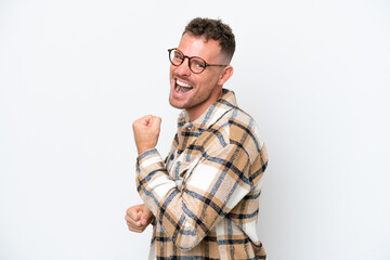 Wall Mural - Young caucasian handsome man isolated on white background celebrating a victory