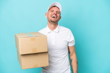 Wall Mural - Delivery caucasian man isolated on blue background laughing