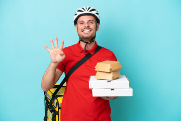 Wall Mural - Young caucasian man with thermal backpack and holding fast food isolated on blue background happy and counting four with fingers