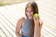 © luismolinero - Young pretty caucasian woman holding an apple with happy expression