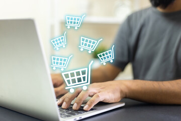 Man using laptop shopping online, shopping cart icon on screen. purchase payment on internet. online supermarket gadget. customer sale and payment.