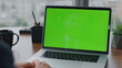 © stockbusters - Businessman working greenscreen laptop in office close up. Man using chroma key