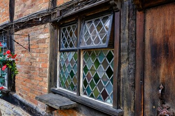 Sticker - Closeup of medieval-style windows of an old building in the daylight