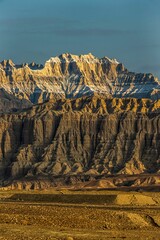 Sticker - Vertical shot of Zanda earth forest during the sunrise in Ali Prefecture, Tibet, China