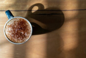 Canvas Print - Top view shot of a cup of coffee on a table