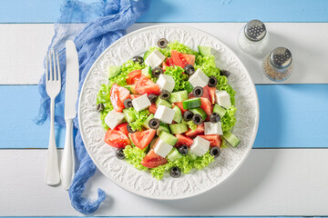 Wall Mural - Full of vitamins Greek salad with olives, feta and lettuce.