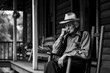 © alexkoral - elderly sad lonely retired man is sitting in chair on porch of house in village. Generative AI