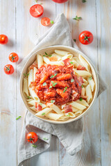 Wall Mural - Tasty and hot penne bolognese with parmesan and basil.