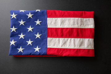 Wall Mural - American flag folded on black abackground, US America National Holiday